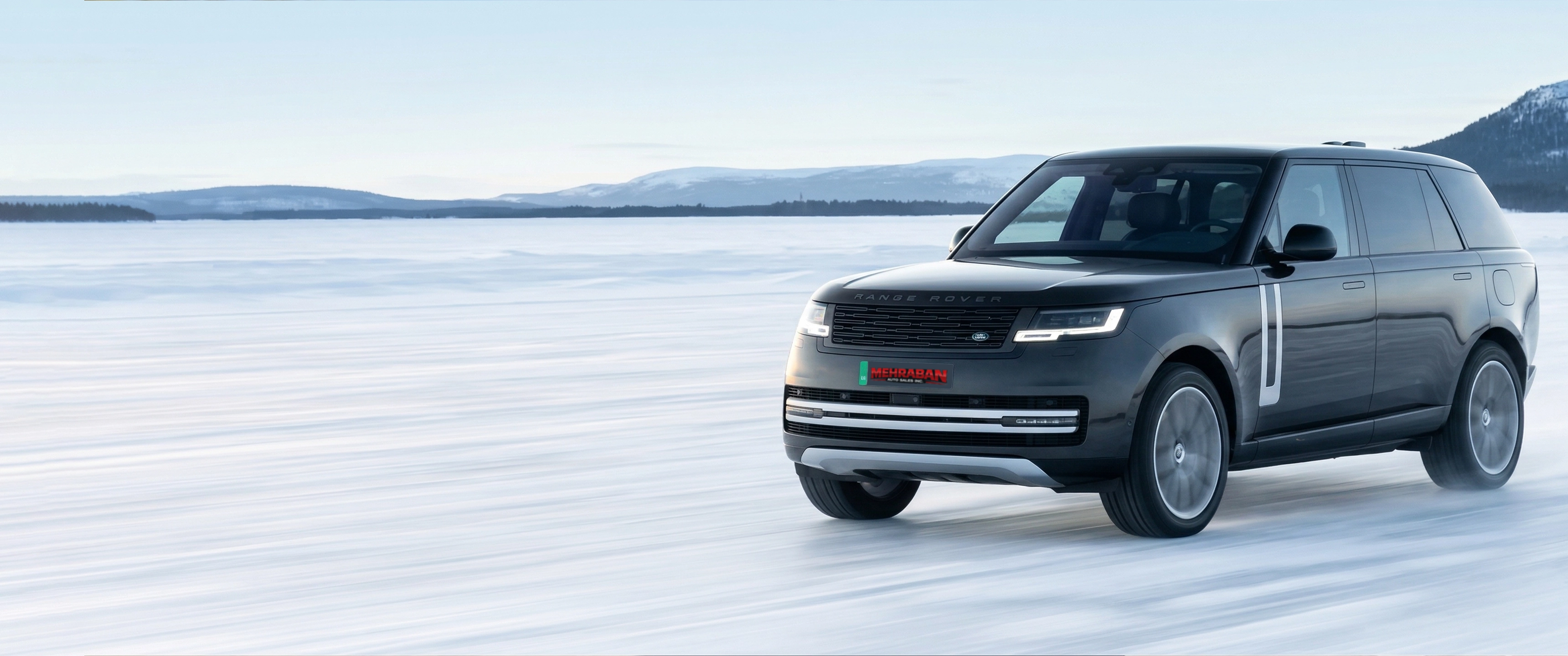 White Mercedes-AMG sedan on a scenic coastal road